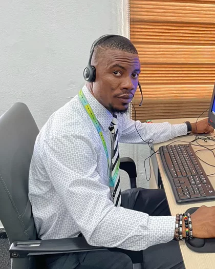 A Kappagee support operator at the Monrovia desk, headset on, watching the fleet on the platform.
